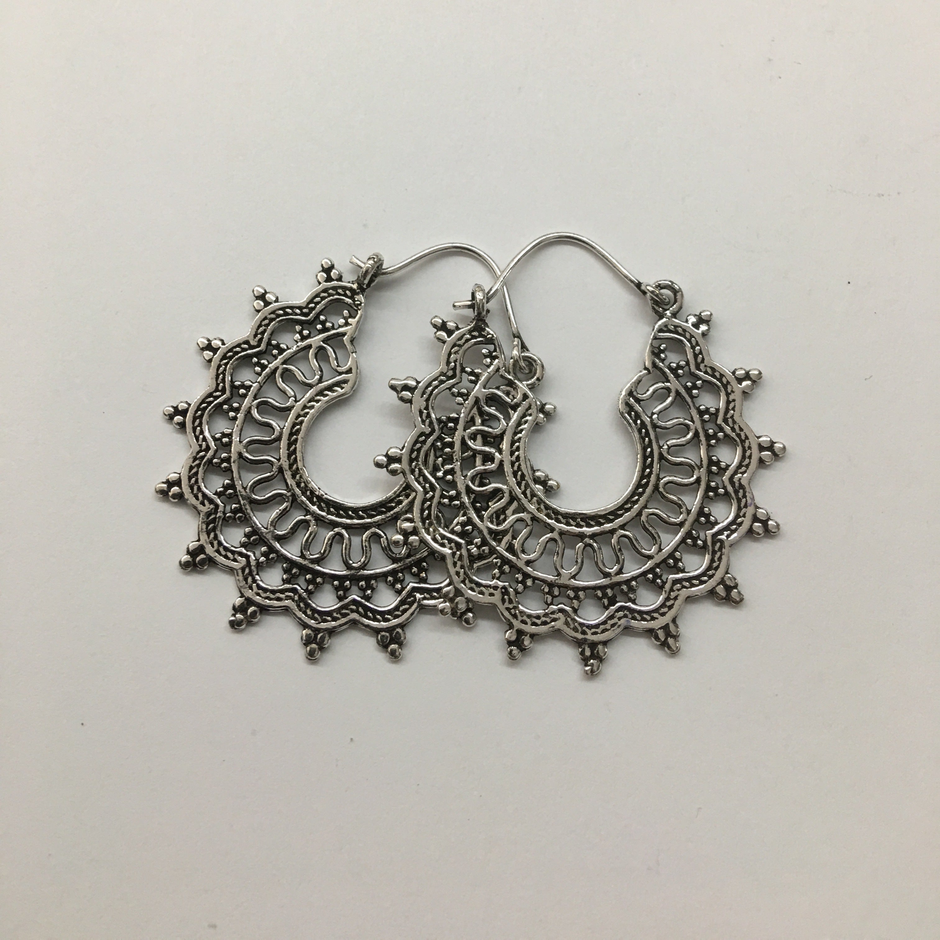 Silver ornate hoop earring